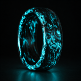 Carbon Storm Aqua Glow ring concept preview showing aqua luminescent forged-carbon swirls in darkness