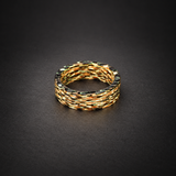 Fire Ghost Matrix carbon fiber ring resting flat, showing warm illuminated layered strands and the inner band