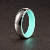 Luminescent Luxe 14K white gold 5 mm ring with Aqua Glow liner, glowing softly in dim light.