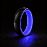Luminescent Luxe 14K white gold 5 mm ring with Indigo liner, glowing powerfully in deep darkness.