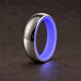 Luminescent Luxe 14K white gold 5 mm ring with Indigo liner, glowing softly in dim light.