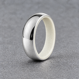Luminescent Luxe sterling silver 5 mm ring with Ultimate Green liner, in daylight, on a subtly cooler gray background.