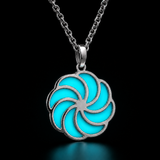 Sterling silver luminous spiral pendant in aqua, shown in daylight