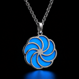 Sterling silver luminous spiral pendant in light blue, shown in daylight