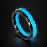 Blue Water Apollo carbon fiber ring glowing aqua blue on a dark background