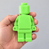 Emerald Green Super Lume Lego Guy held in a hand in daylight for scale