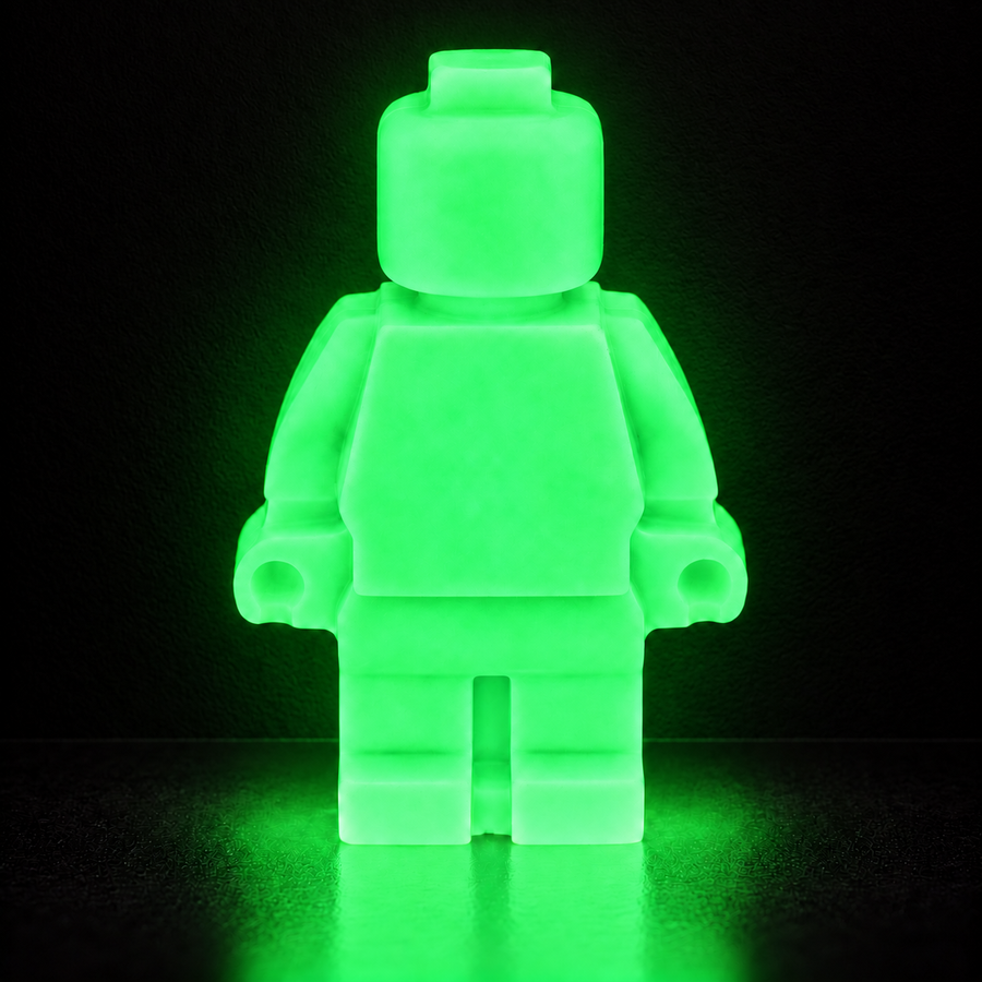 Emerald Green Super Lume Lego Guy glowing brightly against a subtly illuminated black wall