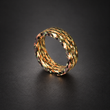 Fire Ghost Matrix carbon fiber ring with warm illuminated layered strands, shown at an upright angle on charcoal