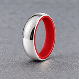 Luminescent Luxe sterling silver 5 mm ring with Fire Glow liner, in daylight, on a subtly cooler gray background.