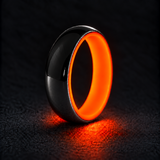 Luminescent Luxe sterling silver 5 mm ring with Fire Glow liner, glowing powerfully in deep darkness, on a subtly cooler gray background.