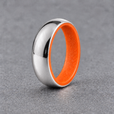 Luminescent Luxe sterling silver 5 mm ring with Racing Orange liner, in daylight, on a subtly cooler gray background.