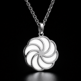 Sterling silver luminous spiral pendant in white, shown in daylight
