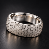 The Hive sterling silver honeycomb ring on a dark background